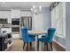 Bright breakfast nook with white table, colorful blue chairs, stainless steel appliances and nice light fixture at 1549 Tappahannock Trl, Marietta, GA 30062