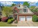 Beautiful two-story home featuring a brick and siding exterior, well-manicured lawn, and two-car garage at 1549 Tappahannock Trl, Marietta, GA 30062