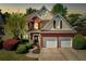 Beautiful two-story home featuring a brick and siding exterior, well-manicured lawn, and two-car garage at 1549 Tappahannock Trl, Marietta, GA 30062