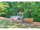 A community gazebo in a wooded area with a bench nearby, perfect for relaxing at 1549 Tappahannock Trl, Marietta, GA 30062