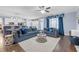 Open-concept living space featuring large sectional, hardwood floors, and seamless flow to kitchen at 1549 Tappahannock Trl, Marietta, GA 30062