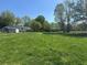Large grassy backyard with mature trees and outbuildings, perfect for outdoor activities and relaxation at 2085 Jones Phillips Rd, Dacula, GA 30019