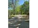Long, secluded driveway surrounded by lush trees and greenery, offering privacy and tranquility at 2085 Jones Phillips Rd, Dacula, GA 30019