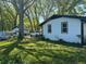 Charming single-story home with white siding, black trim, and a spacious lawn surrounded by mature trees at 2085 Jones Phillips Rd, Dacula, GA 30019