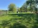 Fenced-in grassy area with mature trees providing shade, perfect for outdoor activities and relaxation at 2085 Jones Phillips Rd, Dacula, GA 30019