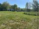 Lush green grass surrounds the plot; outbuildings and trees are on the lot at 2085 Jones Phillips Rd, Dacula, GA 30019
