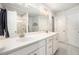 Elegant bathroom featuring double sinks, white cabinets, a large mirror, and a glass-enclosed shower at 214 Gaston Ct, Canton, GA 30115