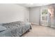 Spacious bedroom with soft carpeting, a window with natural light, and a comfortable queen-size bed at 214 Gaston Ct, Canton, GA 30115