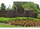 Inviting entrance to Woodmont Golf and Country Club community with brick signage at 214 Gaston Ct, Canton, GA 30115