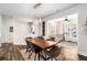 Open dining room with hardwood floors, stylish lighting, and views into the adjacent sitting room at 214 Gaston Ct, Canton, GA 30115