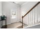 Inviting entryway features wood-look floors, a stylish staircase, and a front door with bright natural light at 214 Gaston Ct, Canton, GA 30115