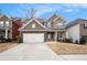 Charming two-story home featuring stone accents, a two-car garage, and a well-manicured lawn at 214 Gaston Ct, Canton, GA 30115