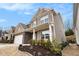 Charming two-story home featuring stone accents, well manicured landscaping, and covered front porch at 214 Gaston Ct, Canton, GA 30115
