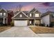 Charming two-story home boasts a well-manicured lawn, inviting entrance and attached two car garage at 214 Gaston Ct, Canton, GA 30115