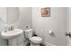 Clean, neutral powder room featuring a pedestal sink and hardwood floors at 214 Gaston Ct, Canton, GA 30115