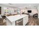 Bright, open-concept kitchen with stainless steel appliances and a large central island overlooking living space at 214 Gaston Ct, Canton, GA 30115
