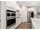Modern kitchen featuring white cabinets, stainless steel appliances, and hardwood floors at 214 Gaston Ct, Canton, GA 30115