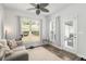 Bright sitting room with large windows, neutral decor, hardwood floors, and views to the backyard at 214 Gaston Ct, Canton, GA 30115