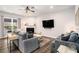 Cozy living room with a fireplace, neutral decor, hardwood floors, and ample natural light at 214 Gaston Ct, Canton, GA 30115
