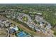 A wide aerial shot captures the expansive community surrounded by lush greenery and featuring a pond at 3972 Church View Ln, Suwanee, GA 30024