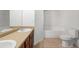 Bright bathroom featuring a double vanity, tub/shower and a toilet at 3972 Church View Ln, Suwanee, GA 30024