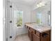 Bathroom with ample natural light, a single sink, and a large mirror at 3972 Church View Ln, Suwanee, GA 30024
