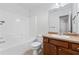 Bathroom features a tub and shower combo and a large vanity at 3972 Church View Ln, Suwanee, GA 30024