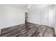 This bedroom offers hardwood floors, neutral walls, and a doorway to the upper level at 3972 Church View Ln, Suwanee, GA 30024