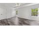 Bright bedroom with a trey ceiling, ceiling fan and two large windows with natural light at 3972 Church View Ln, Suwanee, GA 30024