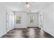Bright bedroom featuring a ceiling fan, wood floors and windows with natural light at 3972 Church View Ln, Suwanee, GA 30024