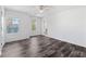 Bright bedroom features hardwood floors, a ceiling fan, and ample natural light from two windows at 3972 Church View Ln, Suwanee, GA 30024