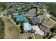 An aerial shot shows the community pool, tennis courts, and clubhouse surrounded by green spaces at 3972 Church View Ln, Suwanee, GA 30024