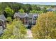 Aerial view of townhome community with mature landscaping and neighborhood trees at 3972 Church View Ln, Suwanee, GA 30024