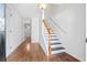 Hallway view featuring hardwood floors, staircase, and doorway at 3972 Church View Ln, Suwanee, GA 30024