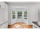 Bright breakfast nook with bay window views, wood floors, and white trim, adjacent to stainless refrigerator at 3972 Church View Ln, Suwanee, GA 30024