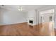 Spacious living room with hardwood floors, fireplace, and an open layout leading to the kitchen and dining areas at 3972 Church View Ln, Suwanee, GA 30024