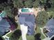 Stunning aerial view showcasing the home's roof, driveway, mature landscaping, and refreshing pool at 2165 Sugarstone Ct, Lawrenceville, GA 30043