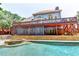 Expansive backyard featuring a multi-level deck, screened patio, hot tub, and refreshing swimming pool at 2165 Sugarstone Ct, Lawrenceville, GA 30043