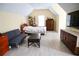 Spacious bedroom with neutral walls, a bed, couch, television, and plenty of floor space at 2165 Sugarstone Ct, Lawrenceville, GA 30043