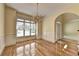 Elegant dining room with hardwood floors, chandelier, wainscoting, and plenty of natural light at 2165 Sugarstone Ct, Lawrenceville, GA 30043