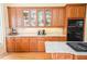Well-lit kitchen featuring wood cabinets, granite countertops, and stainless steel appliances at 2165 Sugarstone Ct, Lawrenceville, GA 30043