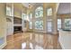 Spacious living room featuring a stone fireplace, hardwood floors, and large windows, offering a bright and inviting atmosphere at 2165 Sugarstone Ct, Lawrenceville, GA 30043