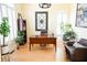 Cozy home office space with wooden floors, a leather chair, and lush greenery, creating a peaceful work environment at 2165 Sugarstone Ct, Lawrenceville, GA 30043