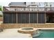 Spacious screened patio area with stone detailing and walkout to patio and in-ground pool at 2165 Sugarstone Ct, Lawrenceville, GA 30043
