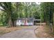 Charming single-story home featuring a cozy front porch and a convenient carport in a wooded area at 2437 Clarissa Nw Dr, Atlanta, GA 30318