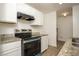Well-equipped kitchen features granite countertops, sleek stainless steel appliances, and bright white cabinetry at 2437 Clarissa Nw Dr, Atlanta, GA 30318