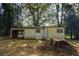 Rear view of home with carport and backyard featuring mature trees at 2437 Clarissa Nw Dr, Atlanta, GA 30318