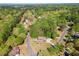 Scenic aerial perspective showcasing a brick house surrounded by verdant trees in a tranquil neighborhood at 244 Saint Patrick Sw Dr, Mableton, GA 30126