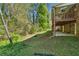 Spacious backyard with a view of wooded area and multi level wooden porch at 244 Saint Patrick Sw Dr, Mableton, GA 30126