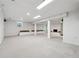 Finished basement with neutral carpet, support beams, recessed lighting, and built-in bench seating at 244 Saint Patrick Sw Dr, Mableton, GA 30126